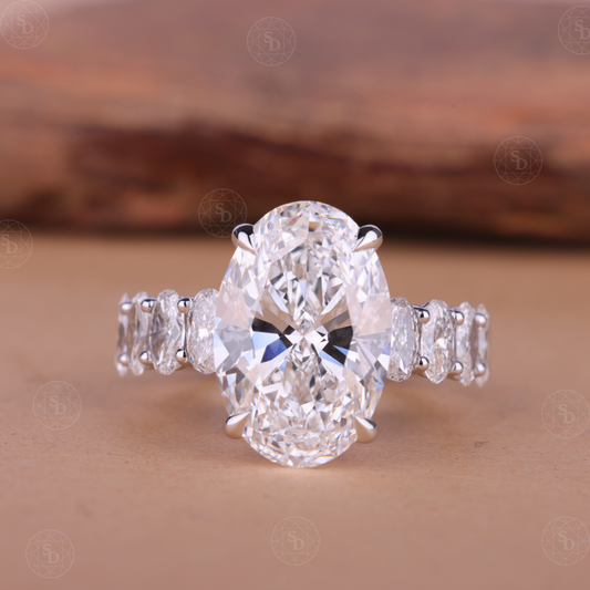 Oval cut lab-grown diamond engagement ring with hidden halo and side stones, IGI certified, set in solid gold with elegant modern design