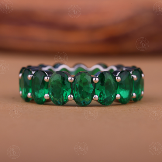 Oval green gemstone synthetic eternity wedding band in yellow gold