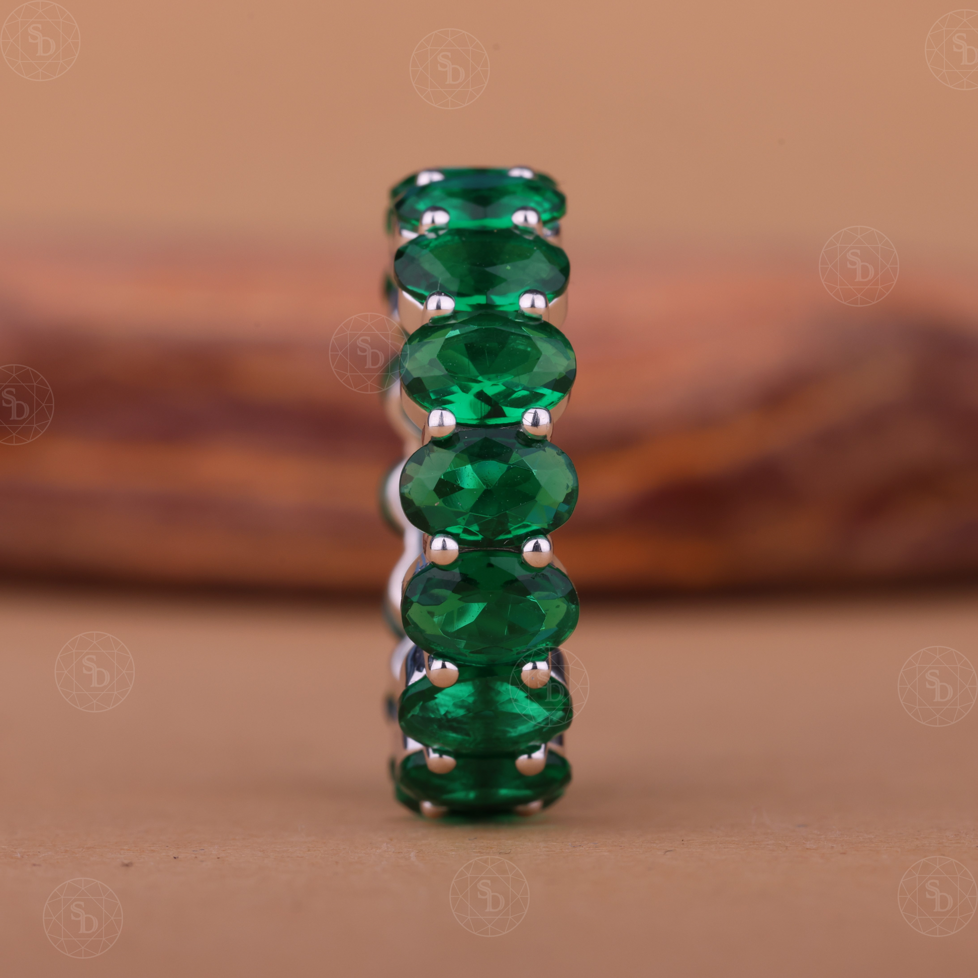 Oval green gemstone synthetic eternity wedding band in yellow gold
