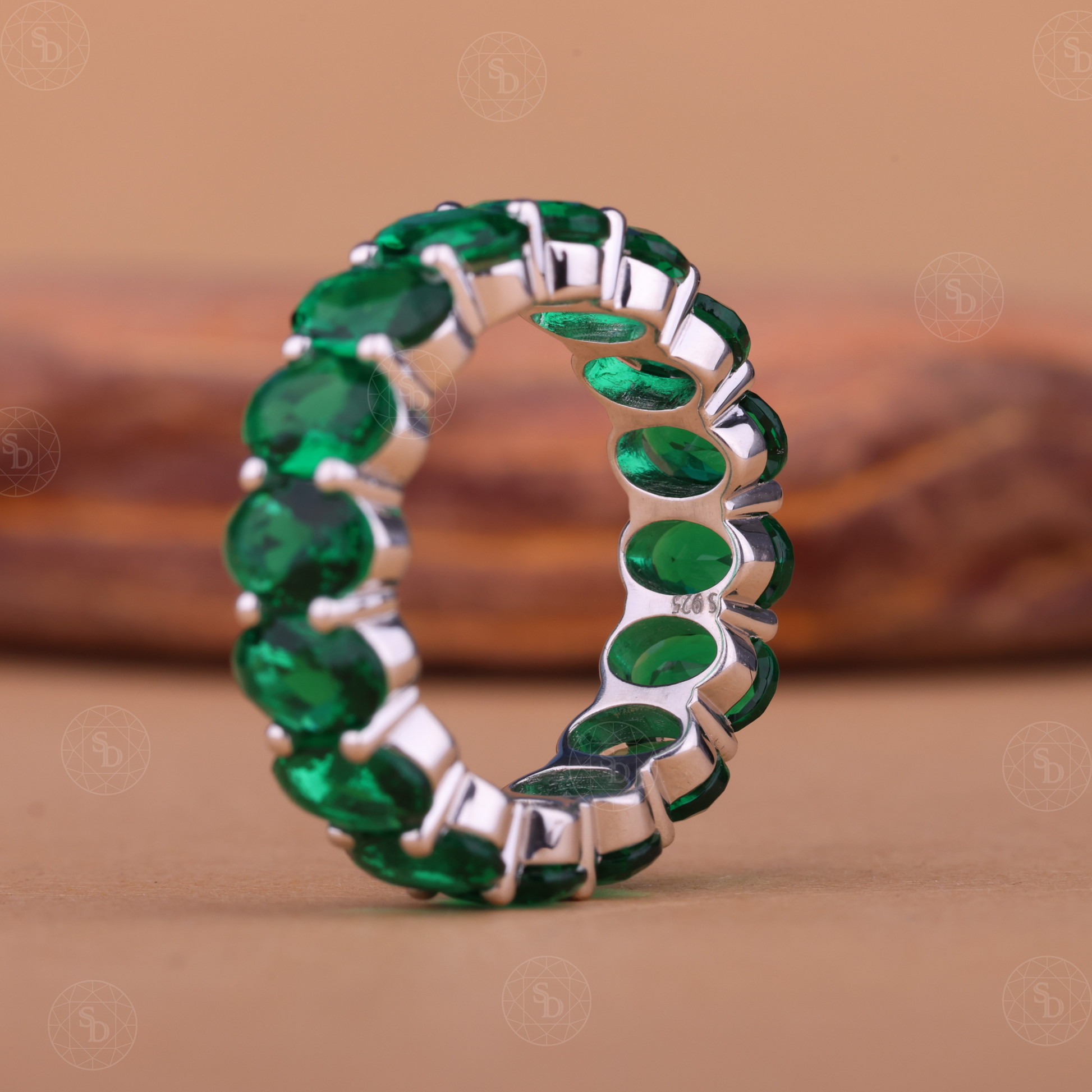 Oval green gemstone synthetic eternity wedding band in yellow gold