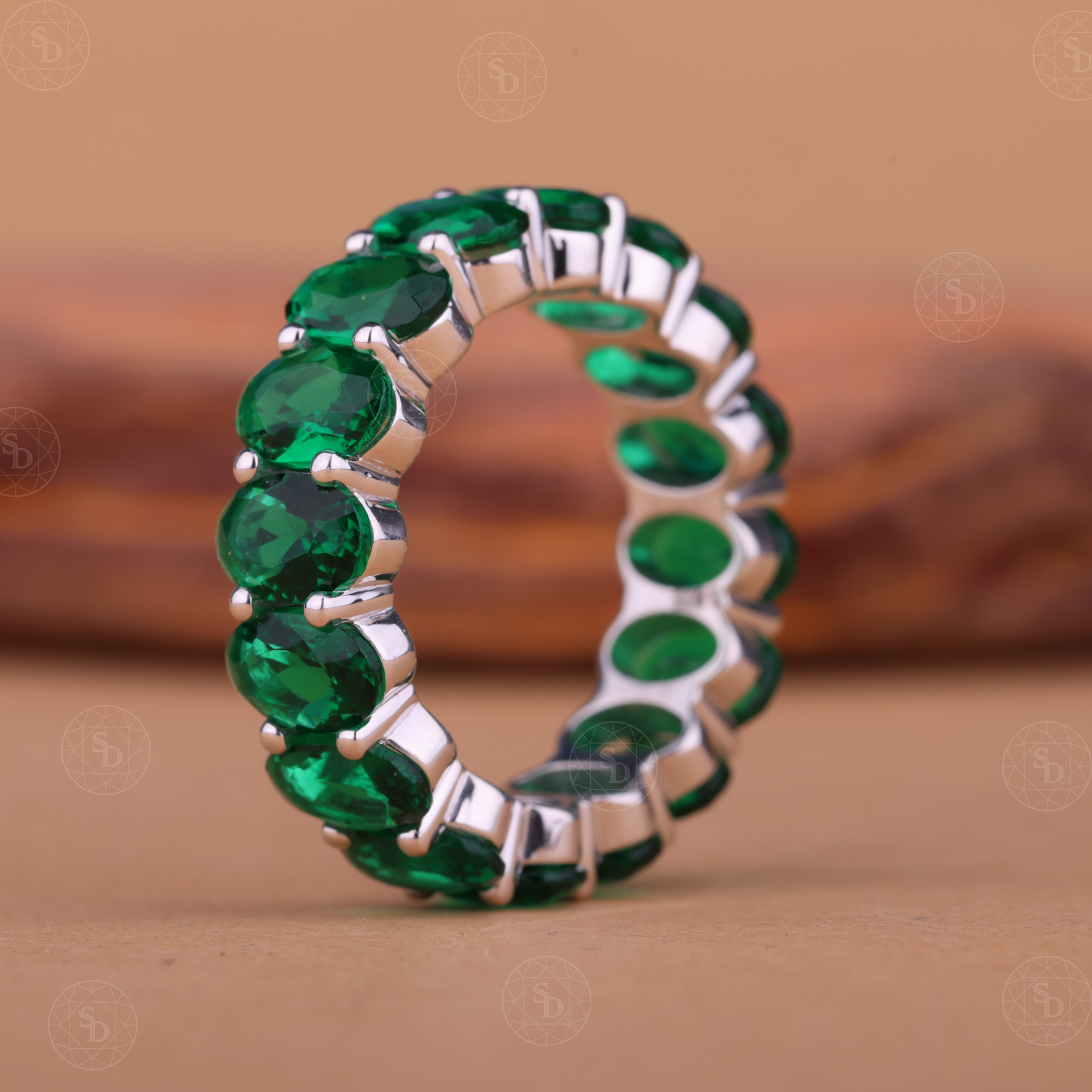 Oval green gemstone synthetic eternity wedding band in yellow gold
