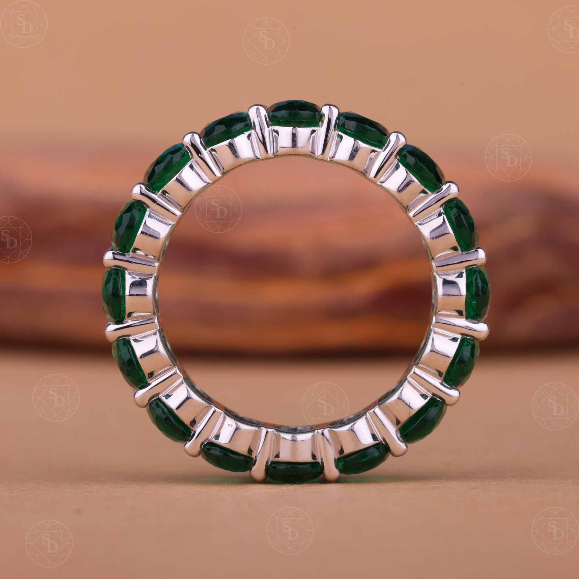 Oval green gemstone synthetic eternity wedding band in yellow gold