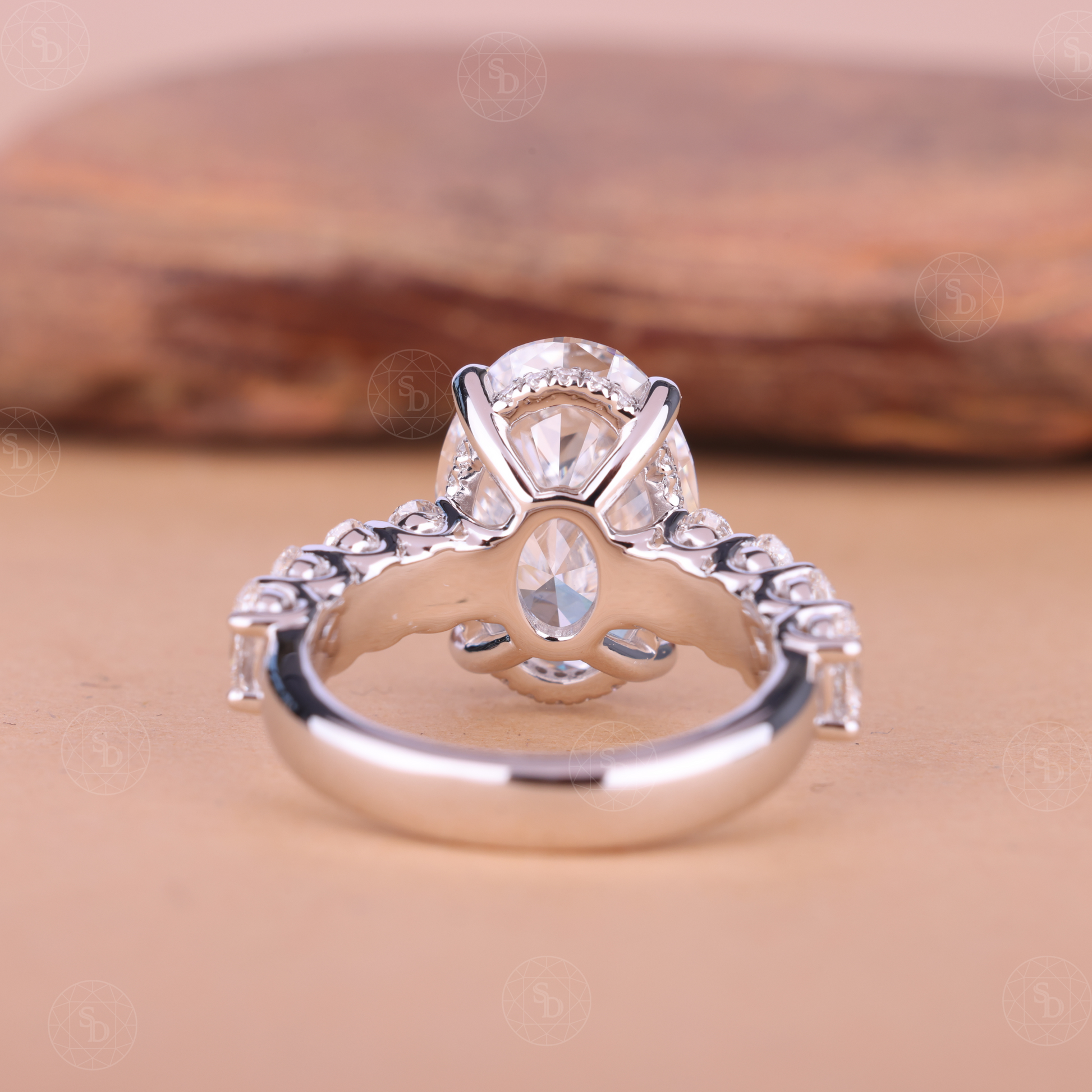 Oval cut lab-grown diamond engagement ring with hidden halo and side stones, IGI certified, set in solid gold with elegant modern design