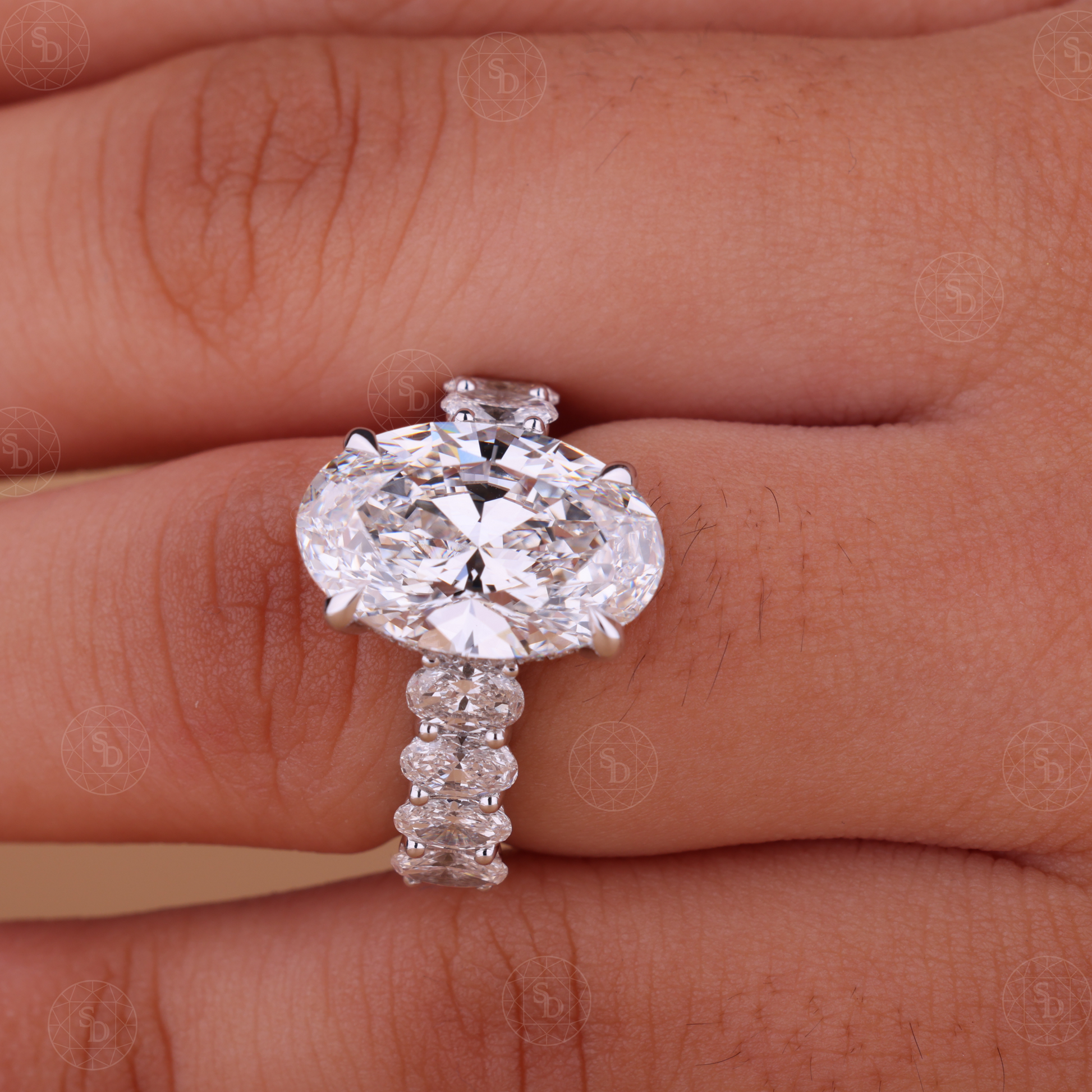 Oval cut lab-grown diamond engagement ring with hidden halo and side stones, IGI certified, set in solid gold with elegant modern design