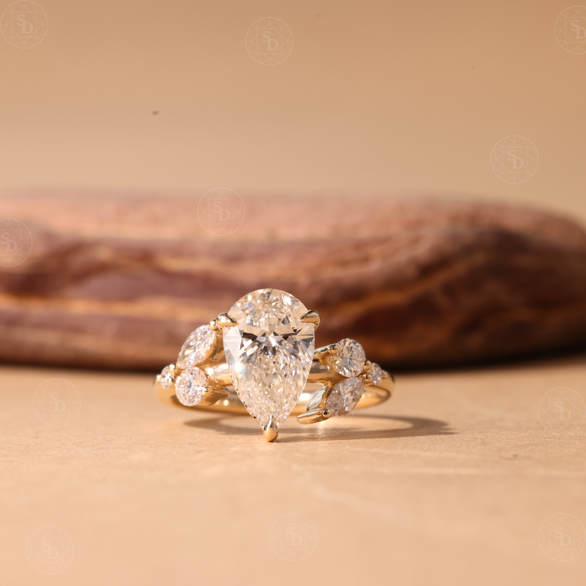 Nature Inspired Pear cut lab diamond engagement ring in 14K gold with hidden halo and marquise round side stones