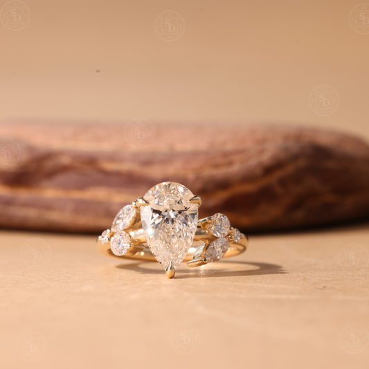 Nature Inspired Pear cut lab diamond engagement ring in 14K gold with hidden halo and marquise round side stones